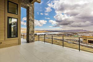 Balcony featuring a water and mountain view