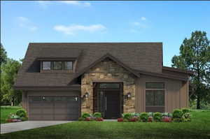 View of front facade with a front yard and a garage