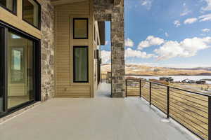 Balcony featuring a water and mountain view