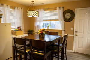 Dining space with hardwood / wood-style flooring