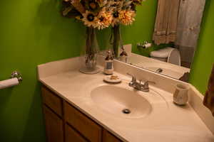 Bathroom featuring vanity and toilet