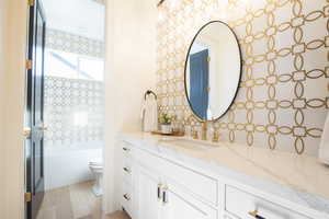 Full bathroom featuring bathtub / shower combination, vanity, hardwood / wood-style flooring, and toilet