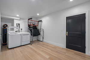 Laundry room featuring light hardwood / wood-style flooring and washing machine and clothes dryer