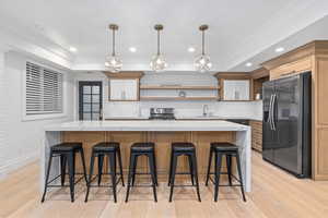 Kitchen with tasteful backsplash, a large island, stainless steel appliances, and a kitchen breakfast bar