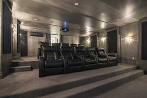 Home theater with a wall unit AC and carpet