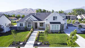 View of front facade with a mountain view and a front lawn