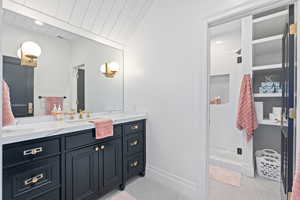 Bathroom featuring tile patterned floors, vanity, wood ceiling, and walk in shower