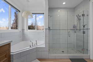 Bathroom with vanity, ornamental molding, and shower with separate bathtub