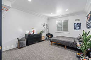 Bedroom with carpet and ornamental molding