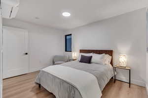 Bedroom with light hardwood / wood-style floors