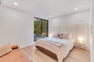 Bedroom with light hardwood / wood-style flooring