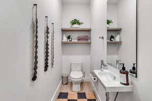 Bathroom featuring hardwood / wood-style flooring and toilet