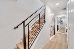 Stairway featuring hardwood / wood-style flooring