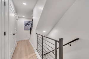 Hallway with light hardwood / wood-style flooring