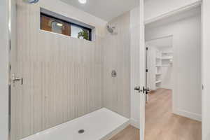 Bathroom with hardwood / wood-style floors and walk in shower