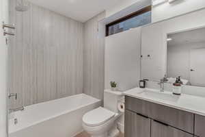 Full bathroom featuring vanity, toilet, and tiled shower / bath