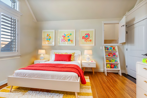 Virtually staged - Bedroom featuring vaulted ceiling, hardwood floors, and cute hidden play alcove.