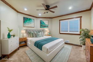 Virtually Staged - Bedroom with ornamental molding, light carpet, and ceiling fan