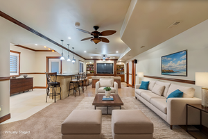 Virtually staged - Carpeted living room with crown molding and ceiling fan