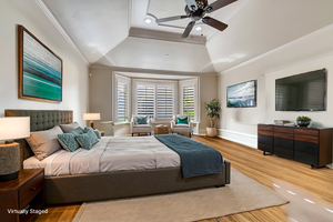 Virtually staged Primary bedroom on main level