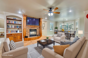 Virtually staged casual living room on main level next to kitchen and dining nook