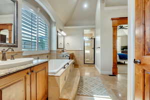 Bathroom with jetted tub, walk in shower, individual vanities, vaulted ceiling.