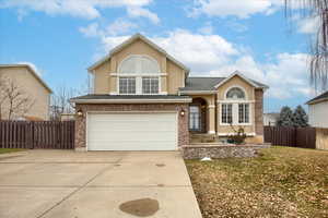 View of front of house featuring a garage and a front lawn