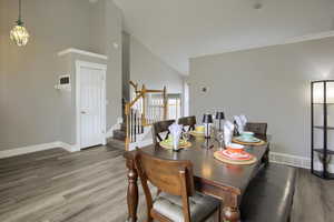 Dining area featuring hardwood / wood-style floors and high vaulted ceiling