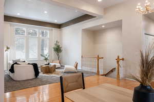 Dining room with hardwood / wood-style flooring and a notable chandelier