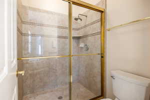 Bathroom featuring toilet and walk in shower