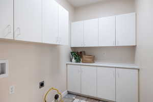 Laundry room with cabinets and hookup for an electric dryer