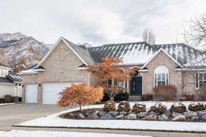 Front facade featuring a mountain view, cooling unit, and a garage