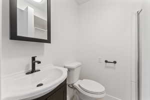 Bathroom featuring new vanity and toilet.