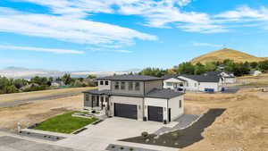 View of front of house featuring a mountain view and a garage