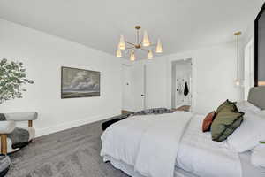 Bedroom featuring carpet and a chandelier