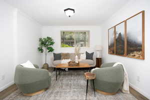 Living area featuring hardwood / wood-style floors and ornamental molding