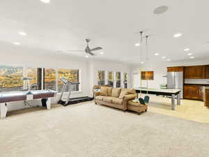 Recreation room with light colored carpet, ceiling fan, crown molding, and billiards