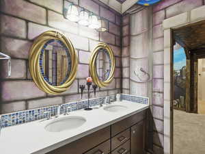 Bathroom featuring tasteful backsplash and vanity