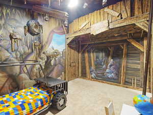 Bedroom with carpet flooring and wooden walls