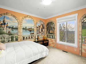 Carpeted bedroom featuring crown molding