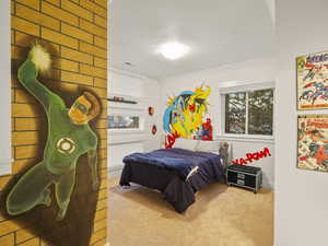 Carpeted bedroom featuring a textured ceiling