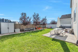 View of yard with a patio area and shed