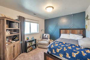 Carpeted bedroom with a textured ceiling