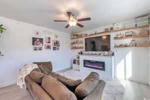 Living room featuring ceiling fan and light wood-type flooring