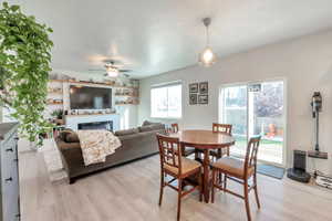 Dining area with light wood-type flooring and sliding glass door.