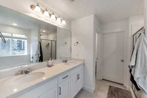 Bathroom featuring tile patterned flooring, double vanity, and independent shower and bath