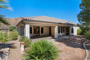 Rear view of property featuring french doors and a patio