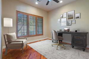 Office featuring hardwood / wood-style flooring and ceiling fan