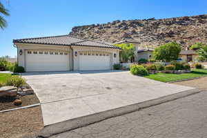 Mediterranean / spanish house with a mountain view and a garage