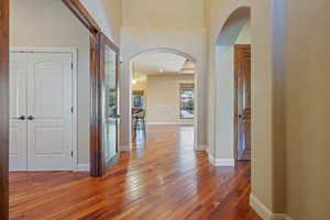 Corridor with dark hardwood / wood-style flooring